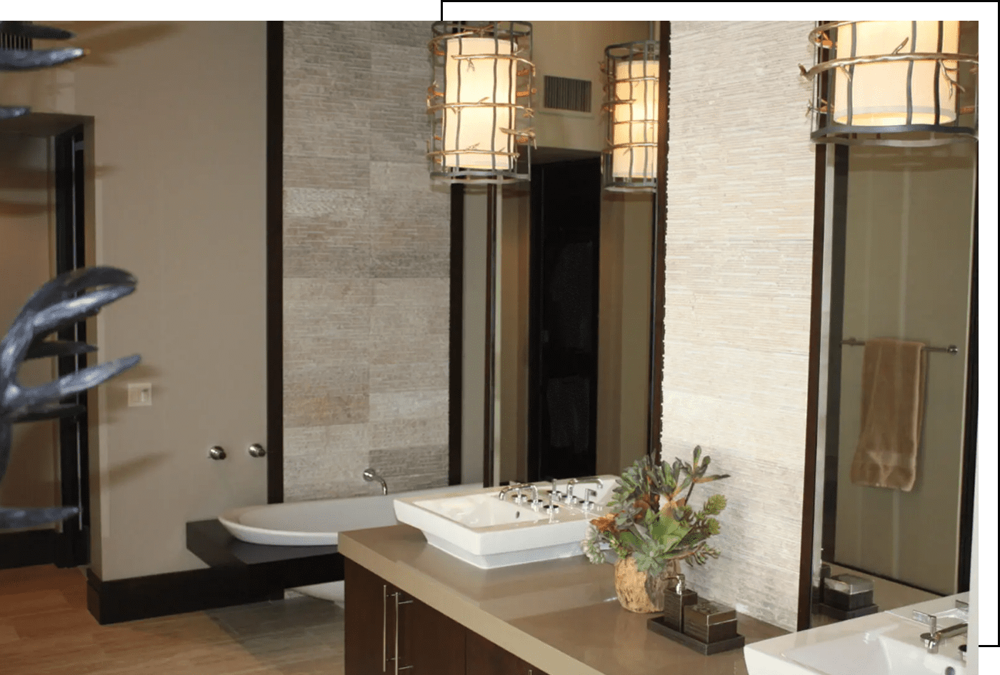 A bathroom with two sinks and a large mirror.